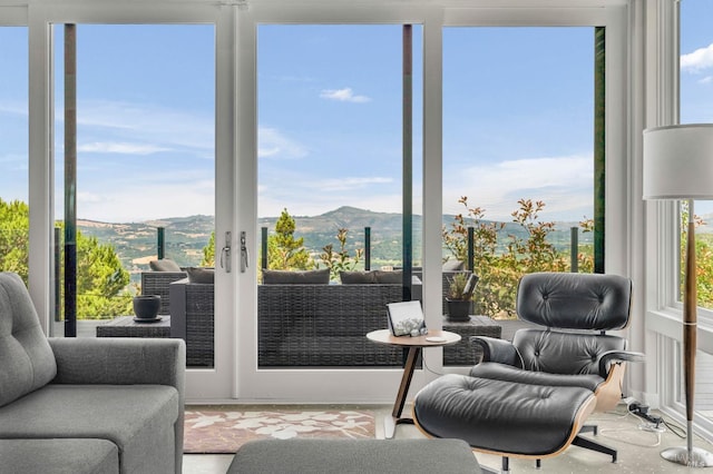 sunroom / solarium featuring a mountain view and a wealth of natural light