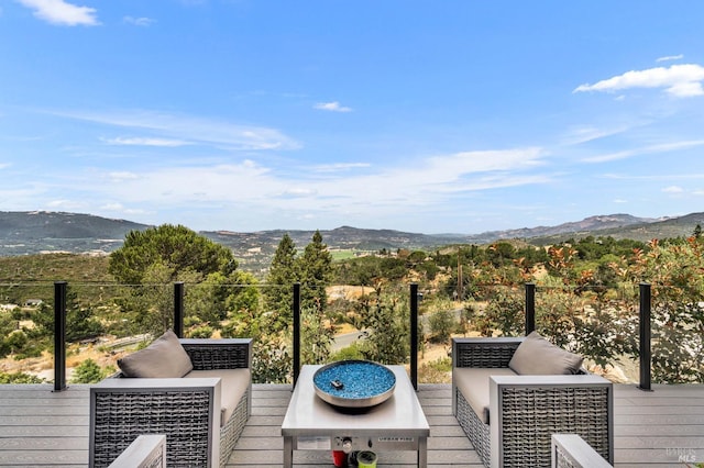 deck with a mountain view and outdoor lounge area