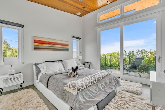 bedroom featuring access to outside and wooden ceiling