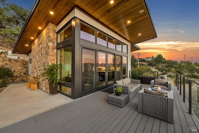 deck at dusk featuring outdoor lounge area