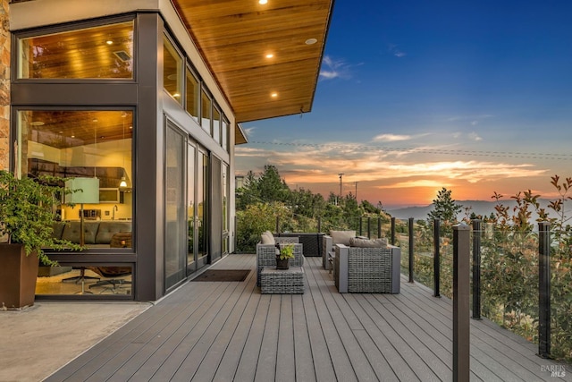 deck at dusk featuring an outdoor living space