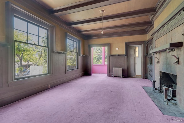 unfurnished sunroom featuring beam ceiling and radiator