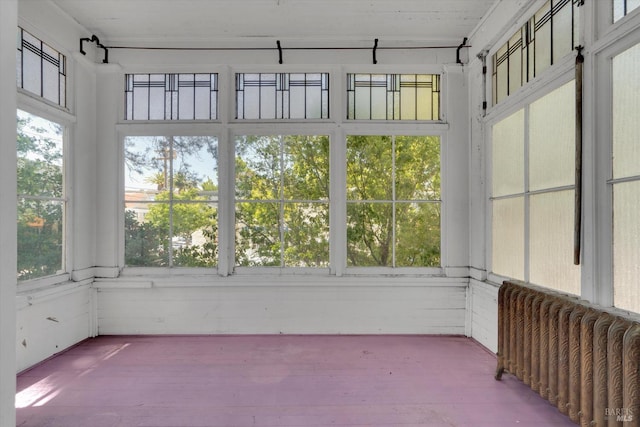 unfurnished sunroom featuring plenty of natural light and radiator