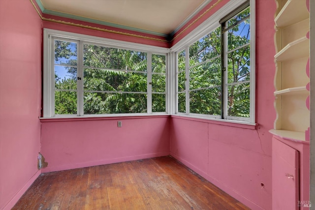 interior space with hardwood / wood-style floors and crown molding