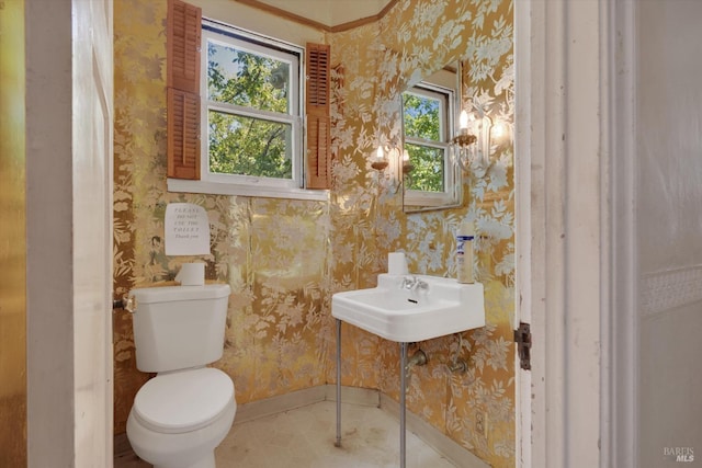 bathroom featuring crown molding, toilet, and tile patterned floors