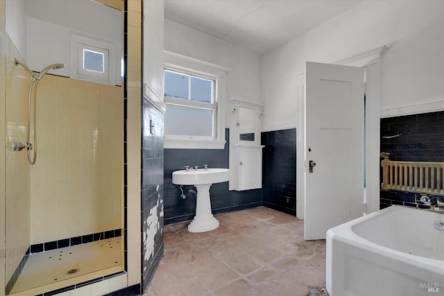 bathroom featuring tile walls, tile patterned flooring, independent shower and bath, and radiator