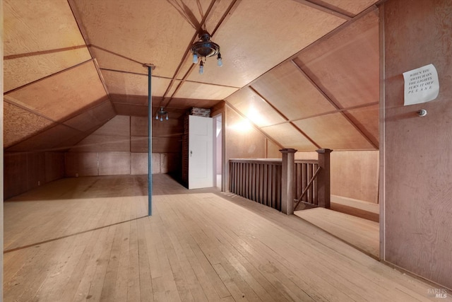 bonus room with lofted ceiling and wood-type flooring