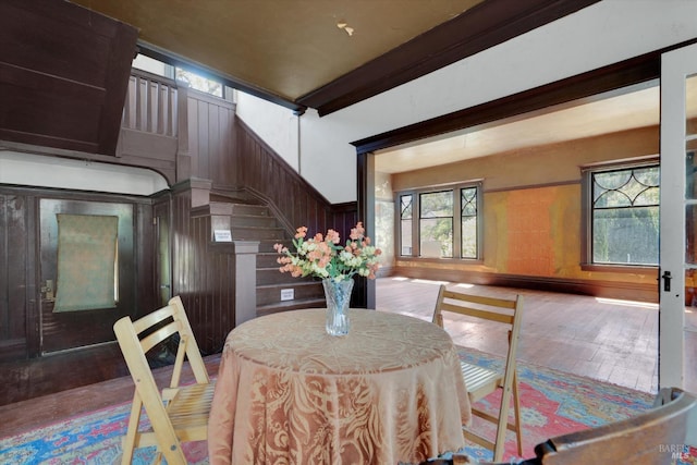 dining area featuring hardwood / wood-style floors and wood walls