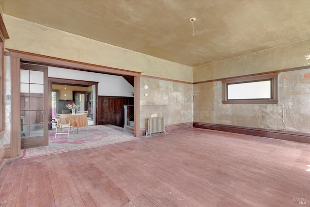 spare room featuring hardwood / wood-style floors and radiator