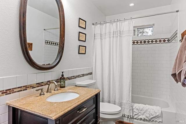 full bathroom with decorative backsplash, vanity, shower / bath combo with shower curtain, tile walls, and toilet