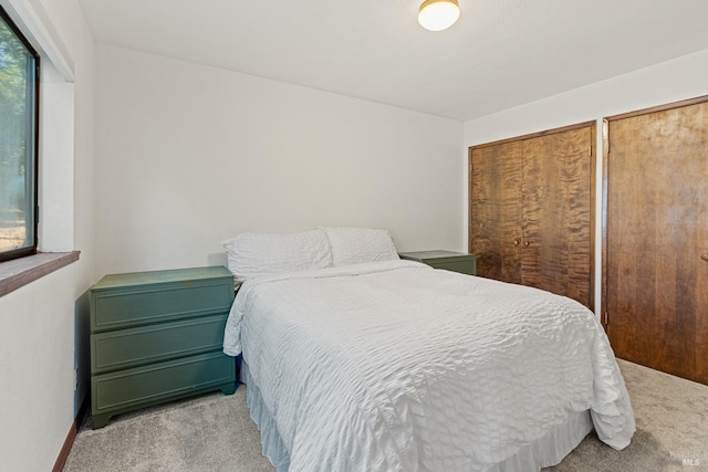 carpeted bedroom with multiple closets