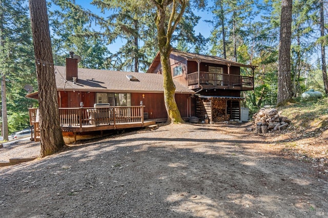 rear view of house with a wooden deck