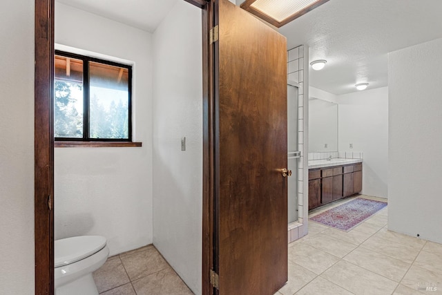 bathroom featuring tile patterned floors, vanity, and toilet