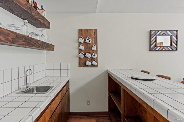 kitchen featuring tile counters, sink, and dark wood-type flooring