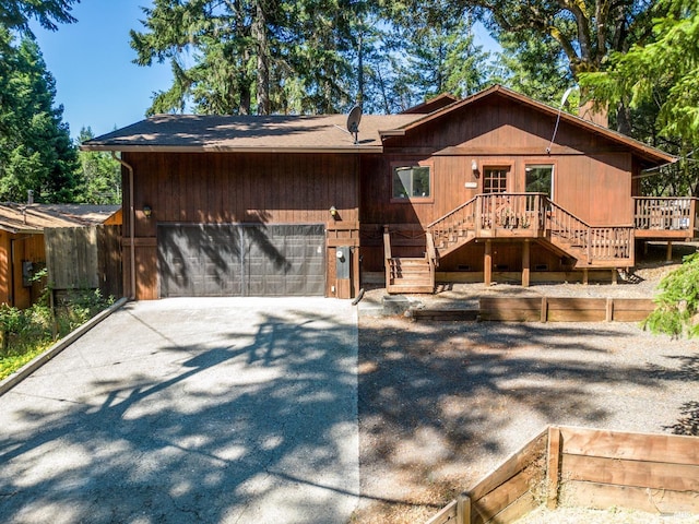 view of front of house with a deck and a garage