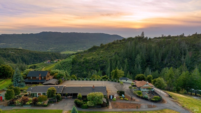 aerial view at dusk featuring a mountain view