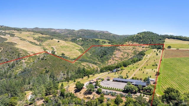 drone / aerial view with a mountain view and a rural view