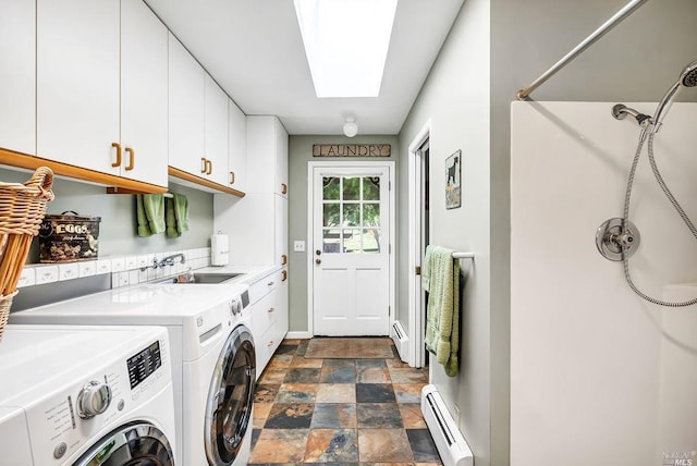 washroom featuring a skylight, separate washer and dryer, sink, cabinets, and a baseboard heating unit