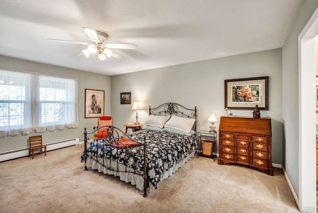 carpeted bedroom with baseboard heating and ceiling fan