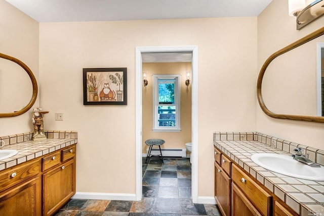 bathroom with vanity, a baseboard radiator, and toilet