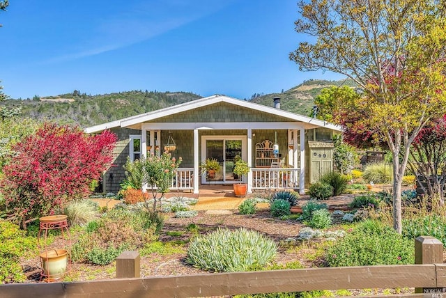 view of front of property with a mountain view and covered porch