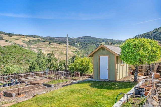 view of yard featuring a mountain view and a shed
