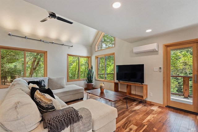 living room with ceiling fan, lofted ceiling, hardwood / wood-style floors, and an AC wall unit