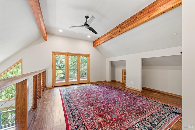 additional living space featuring hardwood / wood-style flooring, ceiling fan, and vaulted ceiling with beams