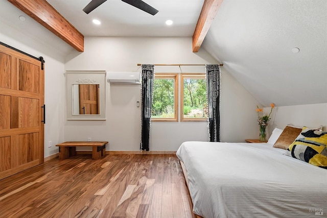 bedroom featuring an AC wall unit, hardwood / wood-style floors, vaulted ceiling with beams, ceiling fan, and a barn door