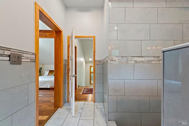 bathroom with tile walls