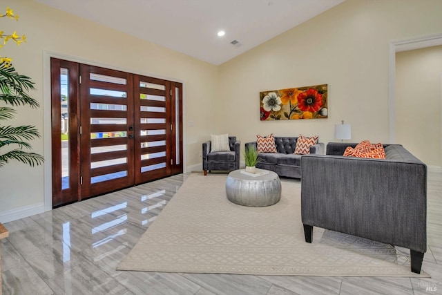 living room with lofted ceiling and french doors