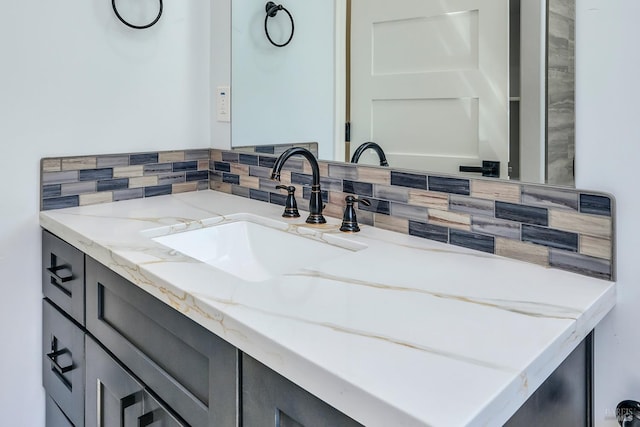 bathroom with vanity and tasteful backsplash