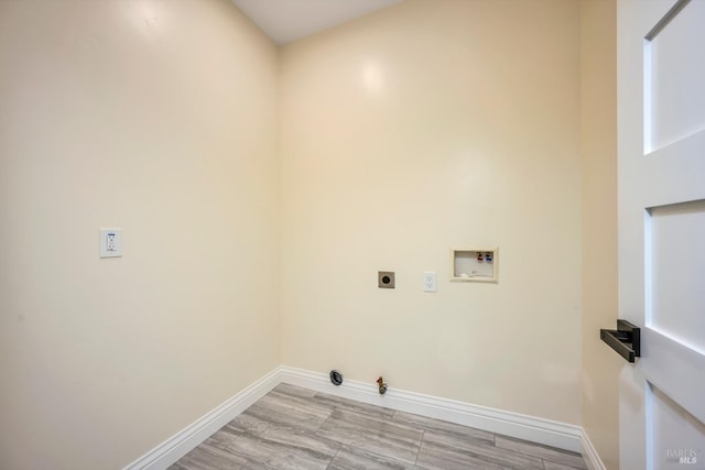 washroom with hookup for an electric dryer, hookup for a gas dryer, light hardwood / wood-style floors, and hookup for a washing machine