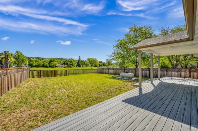 wooden terrace featuring a lawn