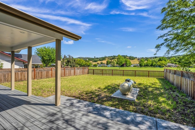 wooden terrace featuring a lawn