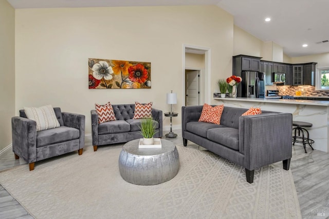 living room featuring hardwood / wood-style floors and vaulted ceiling