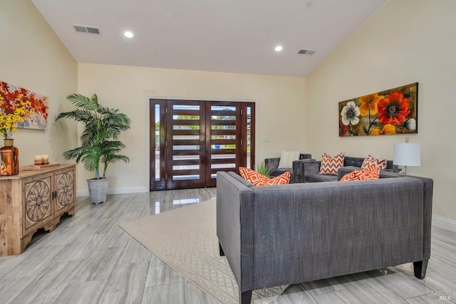 living room with light wood-type flooring, french doors, and vaulted ceiling