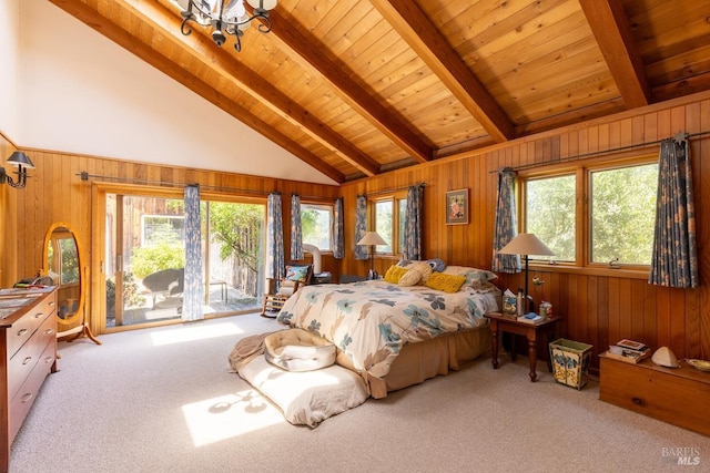 bedroom with access to exterior, carpet, multiple windows, and beamed ceiling