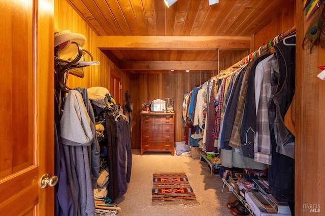 walk in closet featuring carpet flooring and beamed ceiling