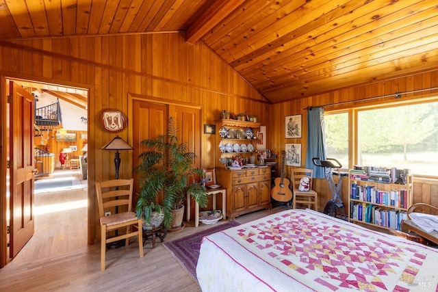 bedroom with lofted ceiling with beams, wood walls, wooden ceiling, and light hardwood / wood-style flooring