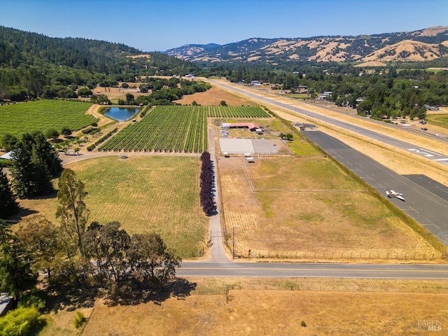 birds eye view of property featuring a mountain view and a rural view