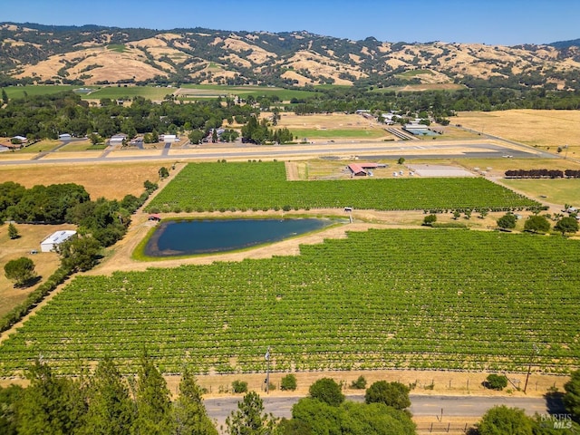 birds eye view of property featuring a rural view and a water and mountain view