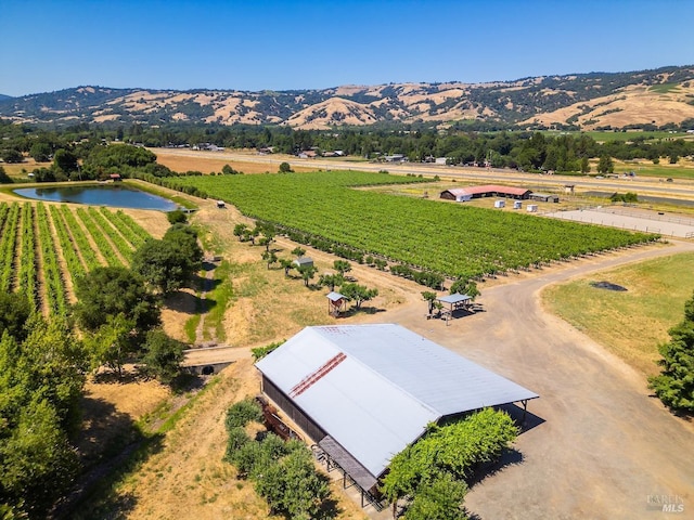 aerial view with a rural view and a water and mountain view