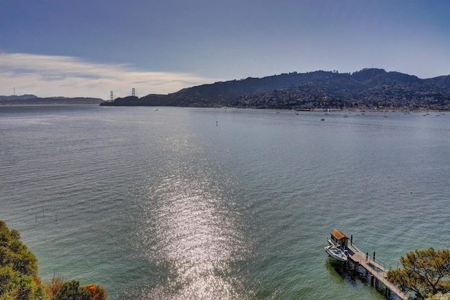 view of water feature with a dock and a mountain view