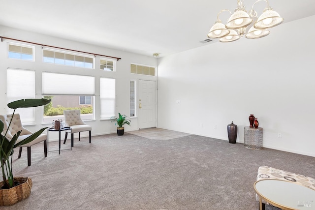 sitting room featuring carpet flooring and a notable chandelier