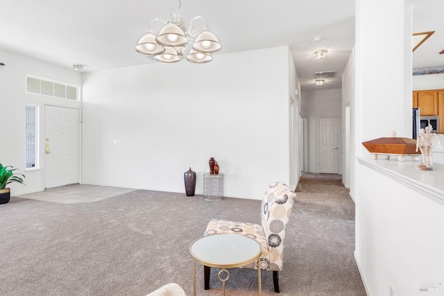 carpeted dining area with an inviting chandelier and visible vents