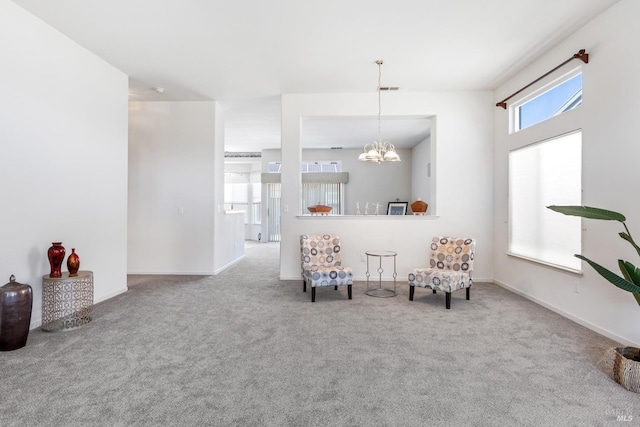 sitting room featuring baseboards, a healthy amount of sunlight, a notable chandelier, and carpet flooring