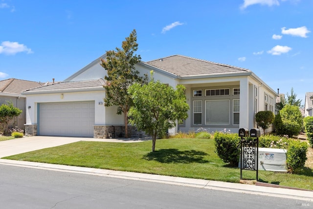 view of front of home featuring stucco siding, a front yard, a garage, stone siding, and driveway