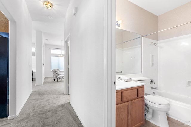 bathroom featuring toilet, vanity, and washtub / shower combination