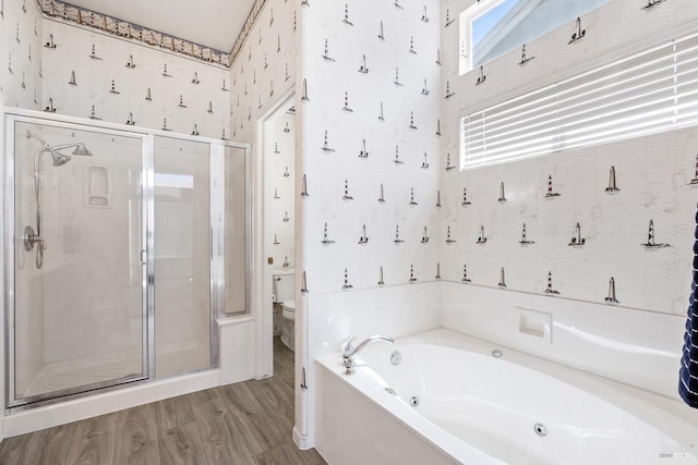 bathroom with hardwood / wood-style floors, toilet, and plus walk in shower